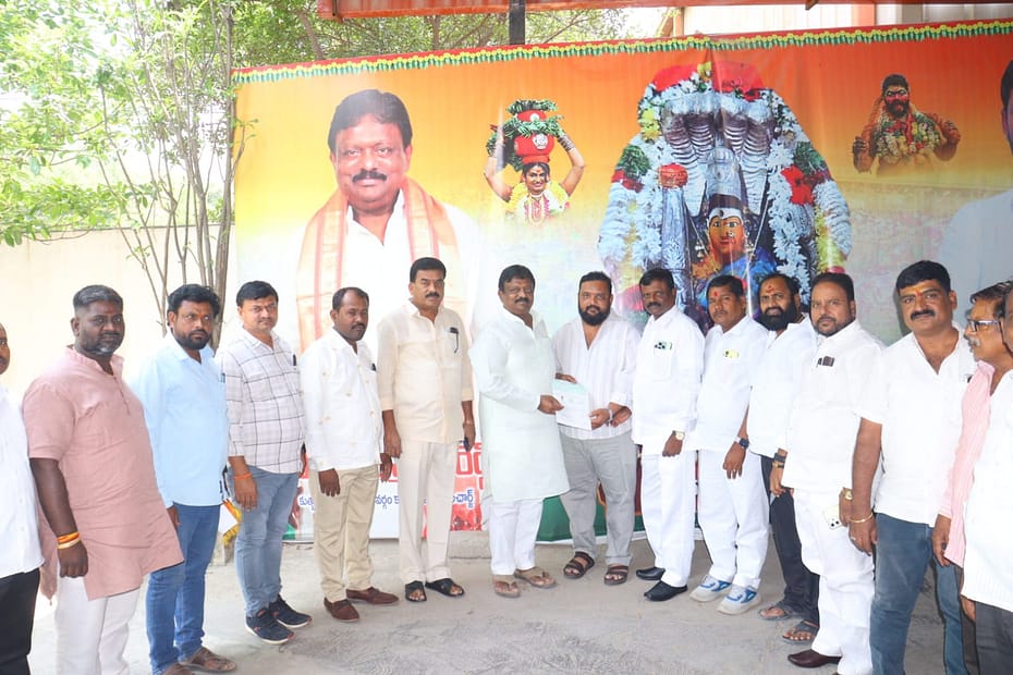 Kolan Hanmanth Reddy distributing CMRF checks to beneficiaries in Quthbullapur.